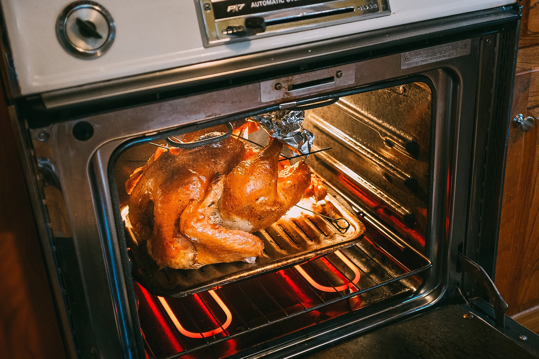 self cleaning oven with a turkey cooking in the oven and the door open